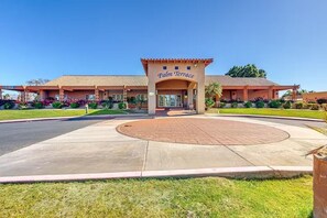 A hotel named Palm Terrace with a central courtyard, multiple buildings, and well-maintained landscaping. - Desert Paradise Enjoy Private Pool & Spa with Game-room, Gym, Bikes&Scooters (Indio)