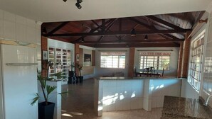 A spacious kitchen with a central island, a refrigerator, and a sink.