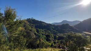 A mountainous landscape with lush greenery and a clear sky.