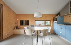 Enjoy meals in the kitchen and dining area with a round table and flat-screen TV.