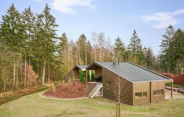 Enjoy the forest views from this cabin's large windows and relax on the small porch.