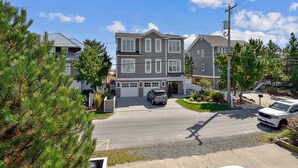 A two-story residential house with a driveway, a garage, and a street view.