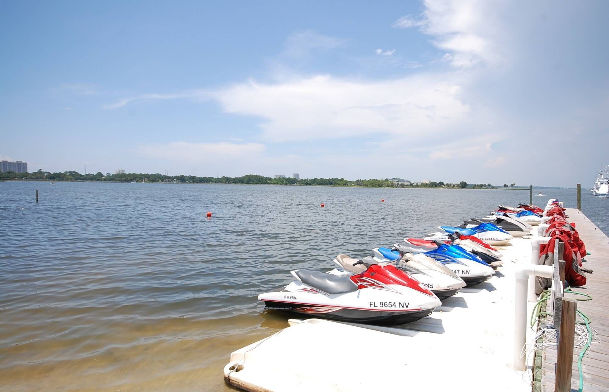 A marina with several jet skis docked at the pier.