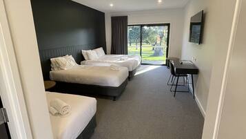 Standard Quadruple Room, Patio, Golf View | Desk, laptop workspace, blackout curtains, soundproofing