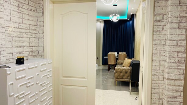 A modern living room with a sofa, chairs, and a TV. - Amazing 3-bedroom apartment with WiFi in Ajman (Ajman)