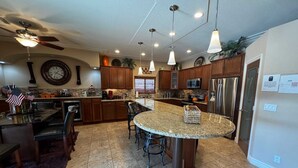 A spacious kitchen with granite countertops, stainless steel appliances, and pendant lighting. - The Moonlight Express (Parker)