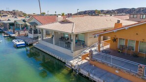 A waterfront property with a dock, a covered patio, and a pool. - Oceans 11, Canal Front Family Fun, 60-FT Dock (Parker)