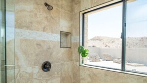 A bathroom with a large window, a shower, and a small plant. - Eagles Lair, Pool & Views! (Parker)