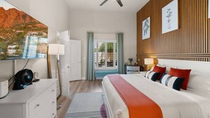 A modern hotel room with a bed, bedside table, lamp, and a view of a mountainous landscape. - Scottsdal:  Pool , 2BR/2BTH - Elegant! (Scottsdale)