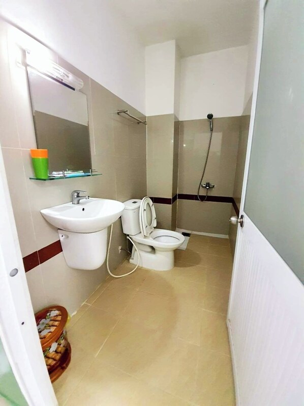 A bathroom with a sink, toilet, and shower.