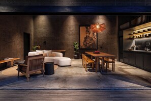 A modern interior with a sofa, dining table, and kitchen area. - Charming 2-bedroom villa in the center of Pererenan with Private Pool (Bali)
