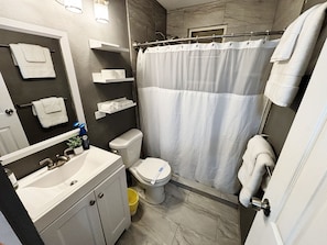 Shower, hair dryer, towels, toilet paper