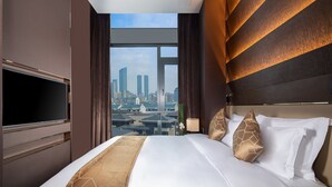 A hotel room with a large bed, a flat-screen TV, and a city view. - Rocase Hotel Wuxi (Wuxi)