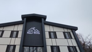 A hotel building with a prominent 'Hills Hotel' sign on the facade. - Hills Hotel karakol (Karakol)