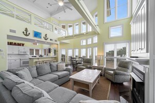 Signature House, 6 Bedrooms, Balcony, Beach View | Living room | 65-inch Smart TV with cable channels, fireplace