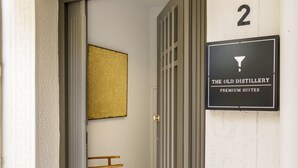 A hotel entrance with a sign reading "The Old Distillery Premium Suites" and a number "2" above it. - The Old Distillery Premium Suites (Rethymno)