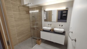 A modern bathroom with a glass shower enclosure, two sinks, and a large mirror. - T4 duplex and rooftop in the heart of Saint-Pierre, this new luxury residence be (Saint-Pierre)