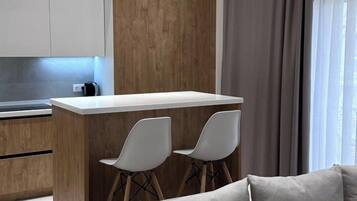 Luxury Apartment, Courtyard View | Living area | Flat-screen TV