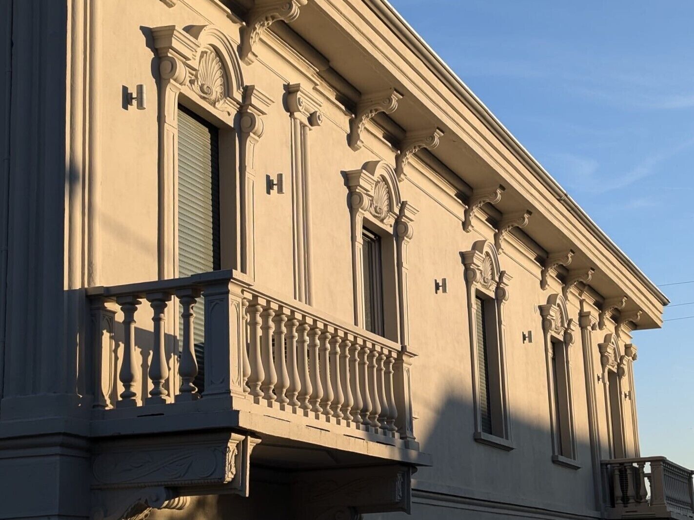 A building with classical architectural features, including ornate columns and a balcony with balustrades.