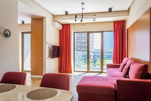Luxury Apartment, Courtyard View | Living area | Flat-screen TV
