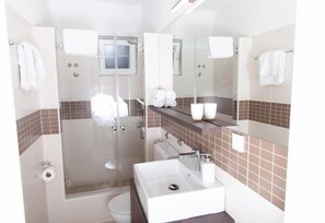 Shower, towels, soap, toilet paper
