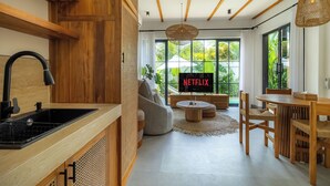 A modern kitchen with a wooden countertop and black sink. - Como Villa by Betterplace (Ubud)