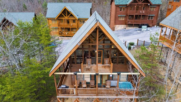 Eine Blockhütte mit Balkon und einer Sitzgelegenheit im Freien.