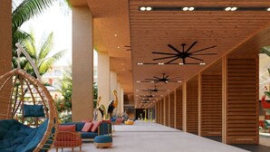 A spacious lobby with a long corridor, wooden ceiling, and ceiling fans. There are seating areas with cushions and a hanging chair. - Fiesta Americana Funeeq Punta Cana All Inclusive (Punta Cana)