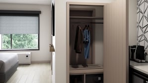 Un dormitorio moderno con cama, vestidor y ventana con persianas.