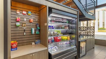A self-service beverage station with various drink options and a selection of snacks.