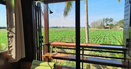 Charming Thai-style villa in lush greenery 10 mins from bus station near city.