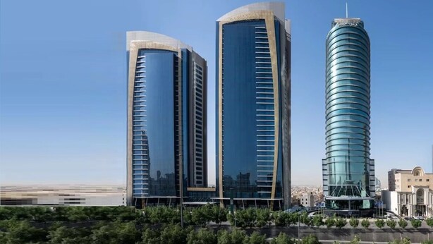Three modern high-rise buildings with reflective glass facades, likely part of a hotel complex. - Luxury Apartment in DAMAC Towers (Riyadh)