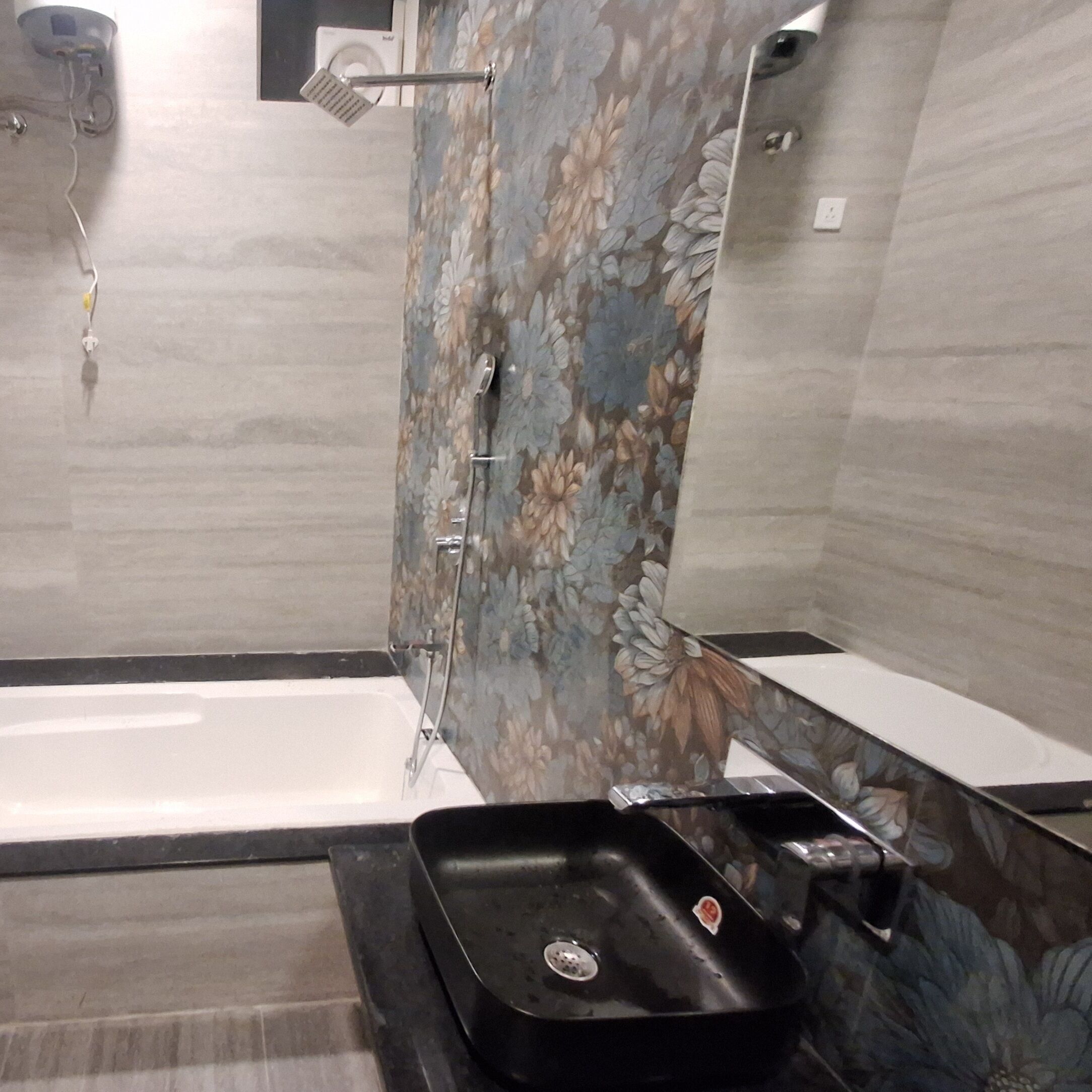 A modern bathroom with a bathtub, a shower area, and a black sink.