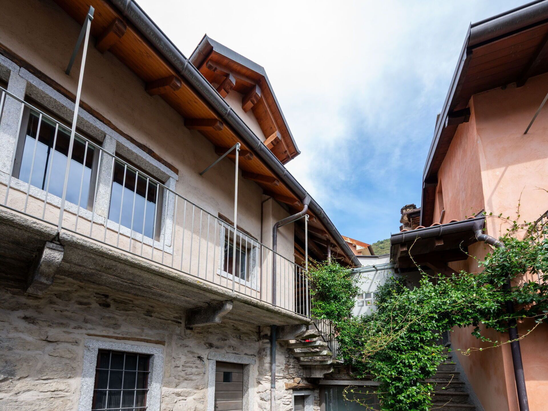 A traditional stone building with a balcony and wooden beams.