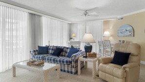 A living room with a sofa, armchair, coffee table, and lamp. - Oceanfront 3 Bdrm Getaway to the Beach Sleeps 6 (Pawleys Island)