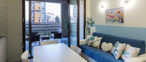 Deluxe Apartment, Garden View | Living area | 50-cm TV with digital channels