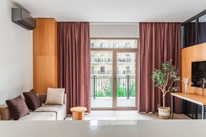 Luxury Apartment, Courtyard View | Living area | Flat-screen TV