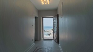 A hallway leading to a beach view with a tiled floor and a ceiling light fixture. - "Villa Mendes" - new seafront villa with a swimming pool (Zastražišće)