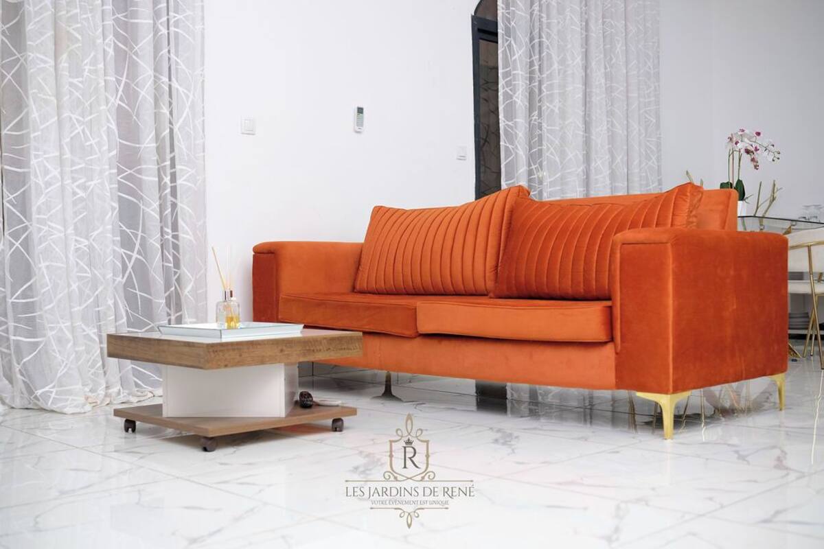 A modern living room with a sofa, a coffee table, and a glass cabinet.