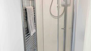 Shower, towels, soap, toilet paper