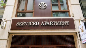 A building with a sign reading "Serviced Apartment" above a large wooden entrance. - Hanoi Bliss Apartment Ba Dinh (Hanoi)