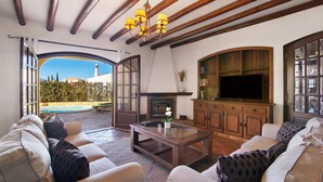 An open-plan living area with a fireplace, television, and seating.