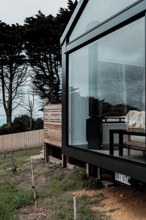 A modern building with large windows, a wooden deck, and a view of the sea. - Swell At Cape Bridgewater (Cape Bridgewater)