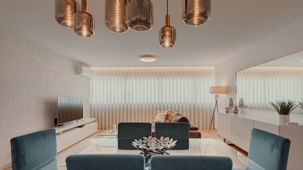 A modern living room with a TV, sofa, dining table, chairs, and pendant lights. - Apartment 'Lux In Porto' with Wi-Fi and Air Conditioning (Porto)