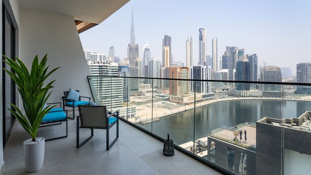 A balcony with a city view, including a river and high-rise buildings. - Easygo- Luxury 1bdr With View Bin Can (Dubai)