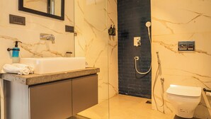A modern bathroom with a marble sink, a glass-enclosed shower, and a toilet. - Lovely 3-bedroom villa in Saligao with WiFi access (Saligao)