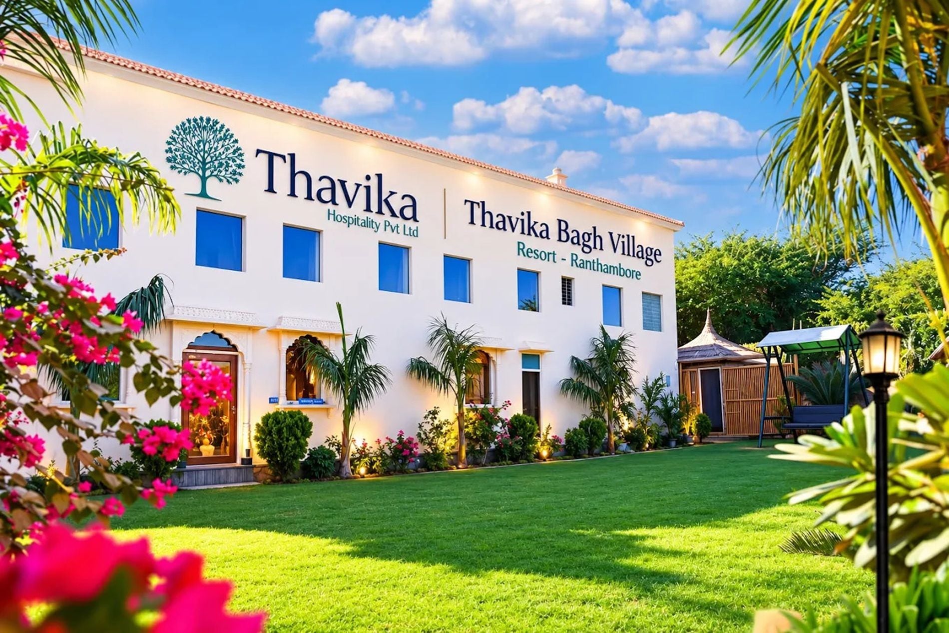 A white building with a sign reading 'Thavika Bagh Village Resort - Ranthambore.'