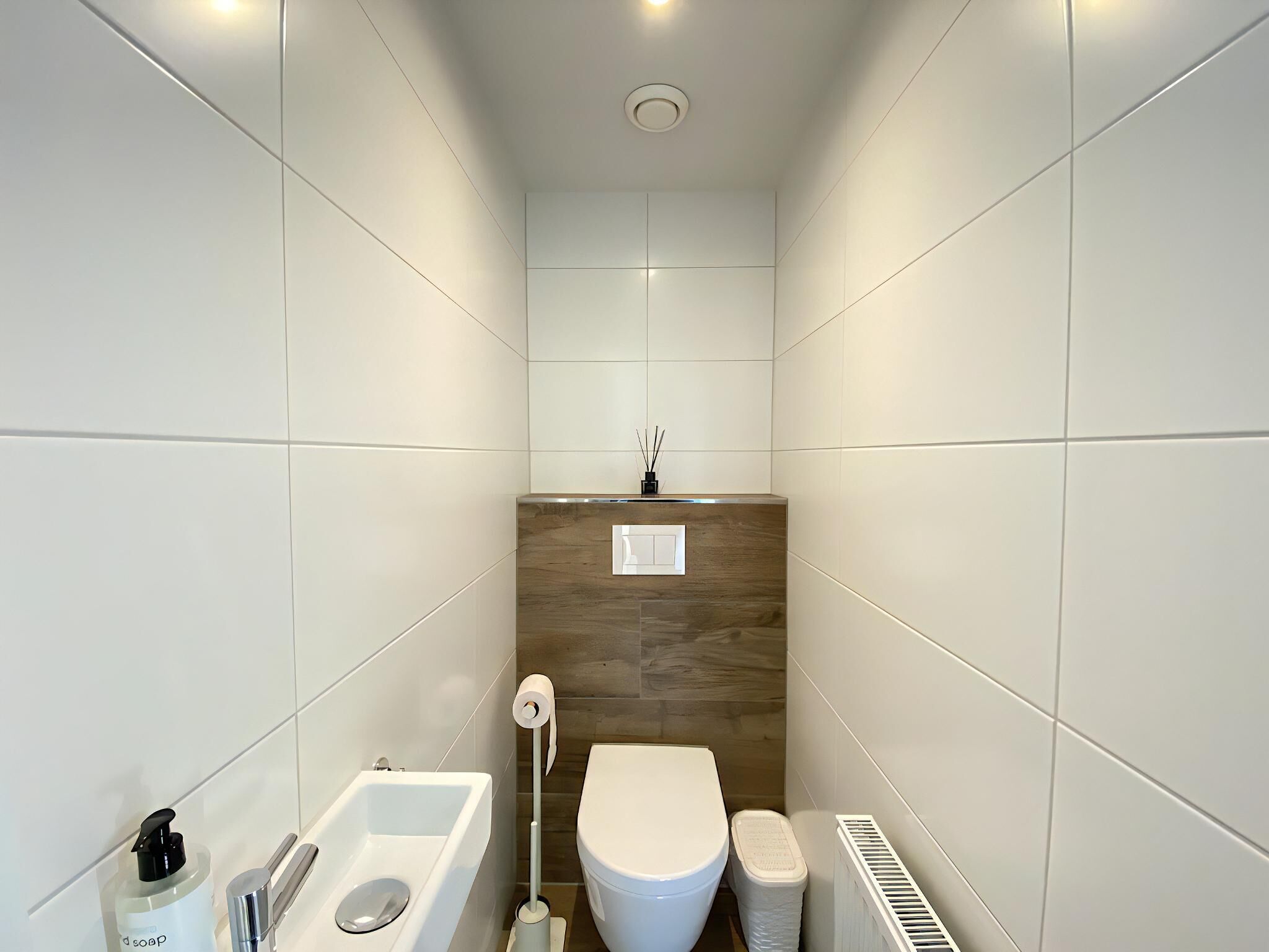Une salle de bain moderne équipée de toilettes, d’un bidet et d’un lavabo.