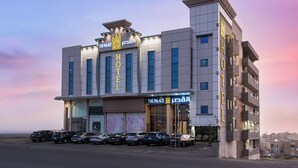 A hotel with a modern design, featuring a prominent sign with the name "The Palace Hotel". - Al Qasr Hotel Suites -Al Tahlia District (Khamis Mushait)