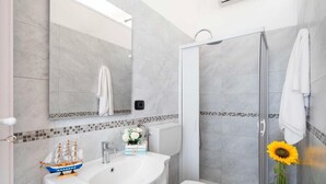 A modern bathroom with a large sink, toilet, and walk-in shower. - Sunny Haven Villa In Torre Lapillo (Porto Cesareo)